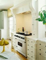 The entire kitchen looks warm and inviting with the teal paint for the cabinets, white tiles for the backsplash, and gold. Kitchens Teal And Ivory Walls Design Ideas