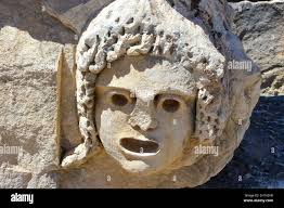 Masks and rock tombs in Myra, Turkey. Ancient tomb by Lycia in Fethiye,  archeology and travel concept Stock Photo