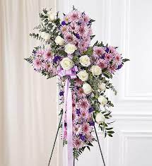 Honor the life of a deceased loved one by sending a plant or funeral flowers to a funeral service. Lavender Standing Cross Main Florist