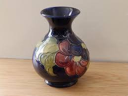 Maybe you would like to learn more about one of these? Lot A Walter Moorcroft Clematis Pattern Dark Blue Vase