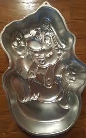 When mario goes near tayce t.'s house, one of the shy guys steals her frying pan and hides it in shy guy's toy box. Super Mario Bros Mario Cake Pan 1872123636