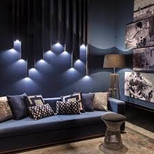 Darker greys can give you a hint try using yellow as an accent to blacks and greys. Geometrical 3d Lights Wall Installation Navy Blue Sofa Accent Wall Ideas Photos Smal Accent Walls In Living Room Accent Lighting Living Room Living Room Colors