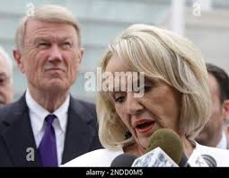 Arizona Gov. Jan Brewer, right, speaks after a hearing she attended, as John  Bouma, left, the attorney for the state of Arizona in the lawsuit brought  by the federal government regarding the