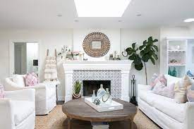 A marble coffee table will be a grand focal point. Transitional Living Room Featuring White Slip Cover Furniture Natural Wood Coffee Table And Decorative Tile Fireplace Surround Hgtv
