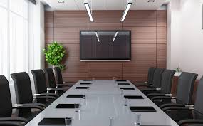 Low angle view of a large table and chairs in a corporate boardroom. 5 Conference Room Setup Best Practices You Should Know