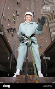 94 year old diminutive great-grandmother Doris Long from Hayling Island in  Hampshire performs her 13th abseil in Portsmouth's Guildhall Square  breaking her own world record Stock Photo