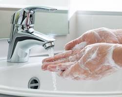 Image of person washing their hands with soap and water