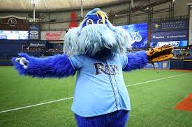 Raymond is a furry blue creature wearing a large pair of sneakers and a backwards baseball cap, completed with a rays jersey. Raymond Raysraymond Twitter