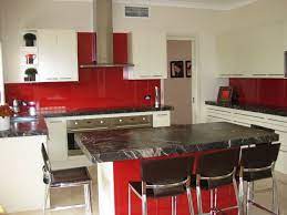 Red Splash Back With Black Benchtop Island And White Cabinets New Kitchen Designs Kitchen Design Kitchen Splashback