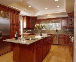 Cherry Cabinets Light Wood Floor With Light Countertops And Stainless Steel Cherry Cabinets Kitchen Kitchen Remodel Layout Cherry Wood Kitchens