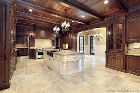 Rich Warm Stained Woods For An Old World Style Kitchen With Contrasting Light Stone Floors And Luxury Kitchen Design Luxury Kitchens Custom Kitchen Cabinets