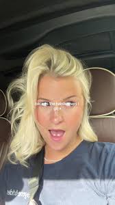 Person Styling Hair in Vehicle with Adidas Shirt