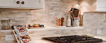 The metallic hue lends rustic appeal and complements the warm butter tones of the kitchen as well as the architectural detailing on the cabinetry and moldings. 5 Awesome Kitchen Backsplash Tile Ideas