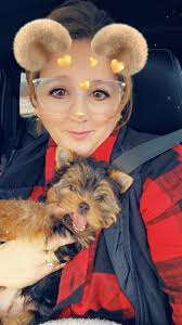 Trimming hair around a 3-month-old puppy's eyes for better vision