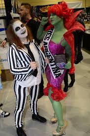 Miss argentina (aka the receptionist , and miss receptionist ) appears at the window in the neitherworld waiting room. Color Everywhere Day One At Eccc Beetlejuice And Miss Argentina