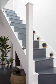 Plants On The Stairs The Perfect Accessory This Interior Style Is So Perfect With The Glass Bannister And Grey Painted Stairs Painted Stairs Glass Staircase