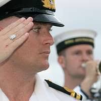 Musician 2nd Class Ryan Ringnalda of Navy Band Mid-South's Brass Ensemble  shakes hands and talks with U.S. Navy veteran (VA) Kathy Stevenson.
