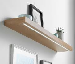 Once the connector pieces are spaced evenly, attach them to the top and bottom of the shelf with wood glue and nails. Oak Floating Shelves Floating Shelves With Lights Floating Shelves