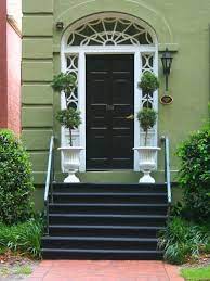 Black trim seems formal and bold, while white trim is striking and dramatic. Love This Mossy Green Home In Savannah Georgia From Betweenyourearsblog Com Green Front Doors Front Door Paint Colors Painted Front Doors