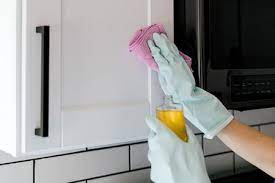 Pour a small amount of the oil soap onto a clean towel, and go over the entire cabinet with a light layer of the oil soap. Tips For Cleaning Food Grease From Wood Cabinets