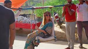 woman being carried in a Sedan chair in ...