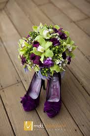 The colors of my wedding was eggplant but i wanted a white bouquet so the flowers were white and the bottom was deep purple. Green Purple Plum Eggplant Gray Feather Cymbidium Orchid Ranunculus Bouquet Wedd Purple Wedding Flowers Wedding Flower Guide Purple And Green Wedding