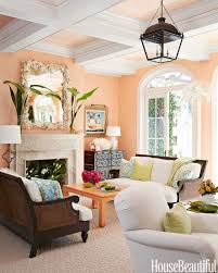 Terracotta design build grounds the light walls and drapery with a dark red area rug and gray arm chairs, while the gold accents pop throughout the space. We Ranked The 35 Best Colors To Paint Your Living Room Paint Colors For Living Room Living Room Color Schemes Living Room Wall Color