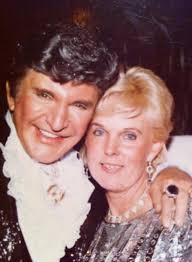 A gorgeous Liberace engaging with the audience at the Palace Theater in New  York