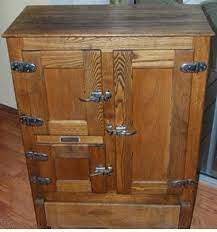 Large antique wooden ice box with decorative hinges and scrollwork design along the bottom panel. Care Of The Ice Chest Ice Box A Hundred Years Ago