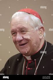 Cardinal Adam Maida smiles when describing a meeting with Pope John Paul II  during a news conference after a prayer vigil and rosary for the Holy  Father at the Blessed Sacrament Cathedral