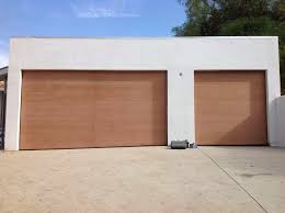 Dramatic arch ways, smooth stucco and decorative hardware are elements that embellish spanish architecture. Contemporary Wooden Garage Doors Ayanahouse