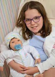 This beautiful new "mommy" poses proudly with her new "baby" she adopted  from my newborn nursery. The baby doll she chose is "Sweet Baby", a soft  bodied baby doll with vinyl head,