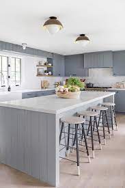 You'll find that modern ceiling light fixtures with single bulbs typically cast low light in a given area. Gray Shiplap Kitchen Island With Black And White Stools Cottage Kitchen
