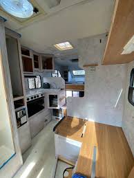 One side contains a slide out refrigerator drawer and the other houses two storage drawers and a slide out for a camping stove with a cooking area and a storage area for plates, pots and pans. Our Truck Camper Remodel Our Beautahful World