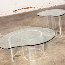 Table has a unique style with intertwined legs and table top with unique edge. Vintage Hollywood Regency Lucite Snail Coffee Side Tables In Style Of Vladimir Kagan Warehouse 414