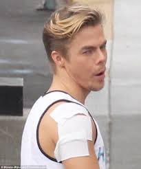 Derek Hough reveals bandaged shoulder backstage at Dancing with the Stars