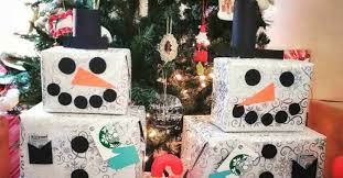 These snowman gift towers become christmas decor pieces in and of themselves! Snowmen Under The Christmas Tree This Year Might Save You Money 12 Tomatoes