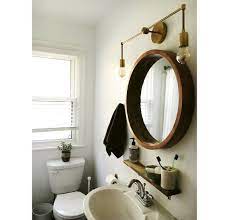 Coffee bathroom round vanity dark cabinets dark wainscoting chocolate earth tones chandelier. Bathroom Lighting Over Round Mirror Trendecors
