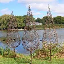 Use Chicken Wire And Plant Morning Glories Or Clematis To Climb Barb Wire Trees From Wire Art Nz Gardenart Garden Art Yard Art Diy Trellis