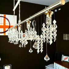 Open breezy dining room nook with ocean art as the focal point. Diy Chandelier From Ikea Just Hang Buckets Of Crystals From Fishing Wire For A Neater Look Diy Chandelier Living Dining Room Ideas Playhouse Decor