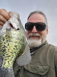 The shoreline of a little fishing pond reflected. Wichita, Kansas, USA