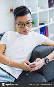 Maybe you would like to learn more about one of these? Handsome Asian Man Glasses Lying Sofa Using Smartphone Home Free Stock Photo C Vitalikradko 217703804