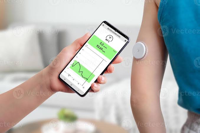 Measurement of blood glucose with the help of mobile app and sensor. Hand brings the phone closer to the sensor located on the child's hand concept 6249719 Stock Photo at Vecteezy