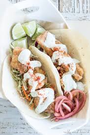 This kind of fish taco is either grilled or fried and topped with either a creamy or vinegar based slaw. Easy And Tangy Oven Fried Fish Tacos Table And Hearth