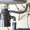Finalizing the draining of a garbage disposal installed in a double bowl sink can be completed simply with an end outlet disposer kit readily available at your home center or hardware store. 3