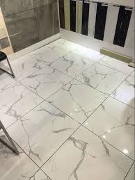 A vanity counter and large floor tiles make this master bath light and airy. What To Choose Marble Tiles Vs Vitrified Tiles Rk Marbles India