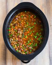 Put the rinsed beans, garlic, onion, salt, pepper, parsley, cloves, ham (chopped into large chunks) or ham hocks into the crock pot along with 6 cups water or broth. Slow Cooker Ham And Bean Soup Healthy Crockpot Recipe