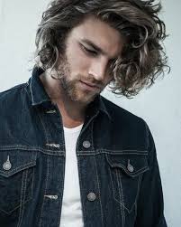 Your long hair needs the nourishing oils from your scalp, since they keep it healthy and hydrated. Denim Jacket Blonde Curly Hair Long Hairstyles For Guys White Shirt White Background Long Hair Styles Men Mens Hairstyles Long Hair Styles