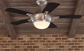 A Large Ceiling Fan With A Light Hangs From A Ceiling In 2020 Ceiling Fan Ceiling Fan Direction Ceiling