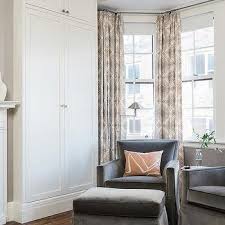 This bedroom features a cozy loveseat tucked under windows for a relaxing sitting area. Master Bedroom Sitting Area Design Ideas